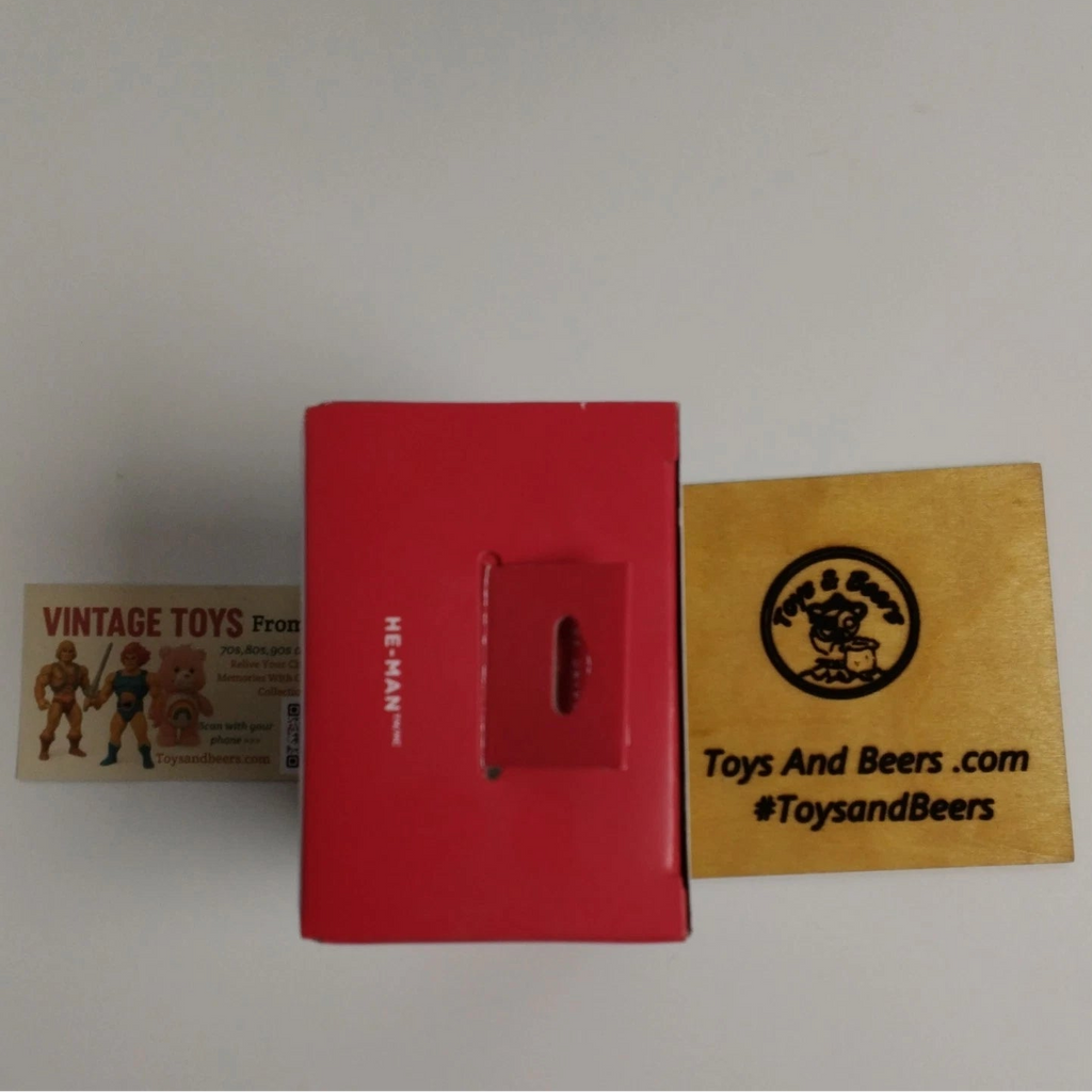 Red toy box with a yellow label featuring text and a logo on a white background